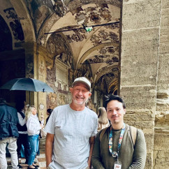 Pausing under ornate arches in a Bologna courtyard.
