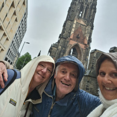 Enjoying a rainy day exploration by a towering church spire.