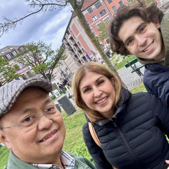 Exploring Munich with smiles under a cloudy sky.