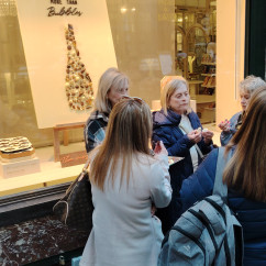 Savoring chocolate delights outside a cozy confectionery.