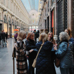 A group gathers around a shop window in Brussels' arcade.