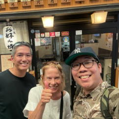 Smiles all around outside a cozy Kyoto eatery.
