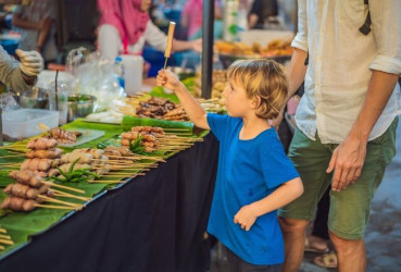 Family exploring a local street food market in Bangkok