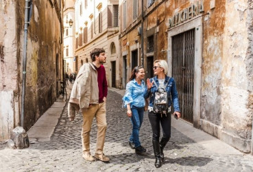 A local guide showing tourists through the cobblestone streets of Rome