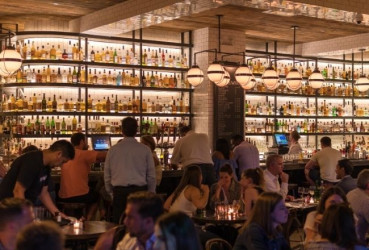 Tourists and locals at a popular restaurant bar in San Francisco