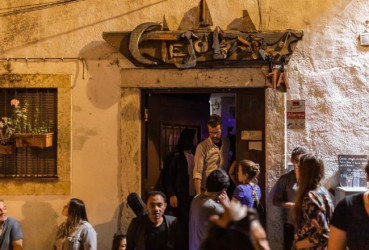 Local guide and tourists heading to a local bar to listen to fado music on a night out in Lisbon