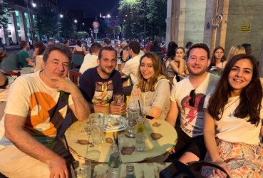 Group of tourists enjoying drinks at a local guide's favorite watering hole in Budapest