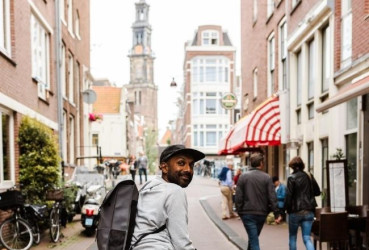 Local cycling down a typical pedestrian street in Amsterdam