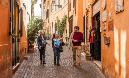 Tourists exploring the cobblestone streets of Rome with a local guide