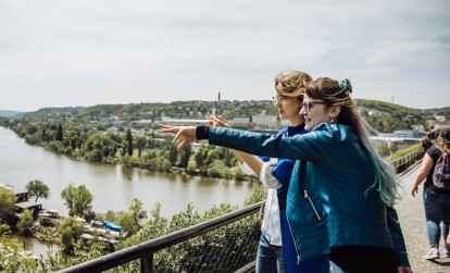 Tourists taking in the sights of Prague on a bridge over the Vltava river