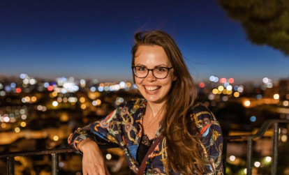 Tourist enjoying the views of the city below on a night tour of Lisbon