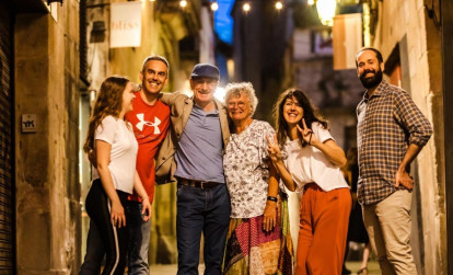 Tourists enjoying a night tour of Barcelona with a local guide