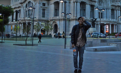 Tourist standing in front of a popular attraction while on a night tour of Mexico City