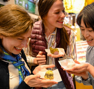 Happy travelers enjoying local specialities on a walkin