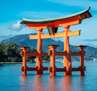 Red Torii Gates in Lake Ashi with mountains in the back