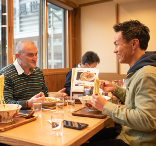 People enjoying a plate of traditional Japanese c