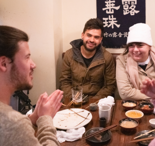 Travelers enjoying Japanese food