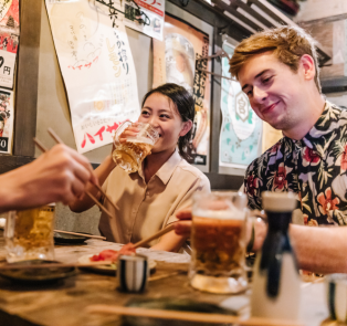 Group having drinks and Japanese food 