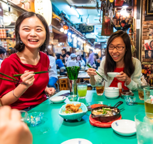 People at a restaurant, eating Japanese food