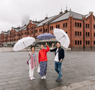 Visitors standing in front of the red brick warehouse