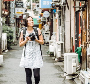 Tourist taking photos of her visit, Tokyo