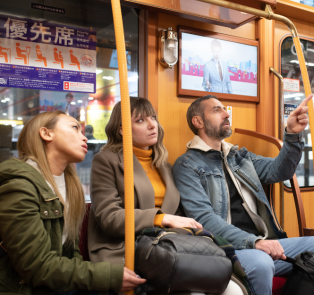 Tourists on public transport in Tokyo, Japan