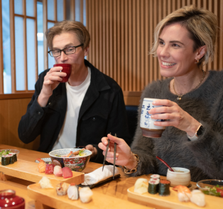 Visitors eating Traditional Japanese sushi