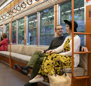 Couple traveling by train to visit Tokyo