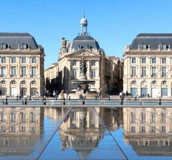 city,facade,landmark,palace,tourist attraction,reflection,classical architecture,town square,medieval architecture,plaza,water feature
