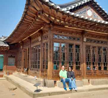 Relaxing in the sunshine outside a traditional Seoul building.
