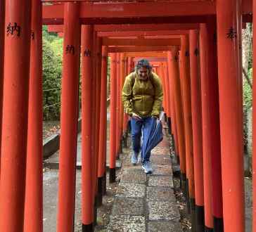 Traveler's Passage Under Vibrant Torii