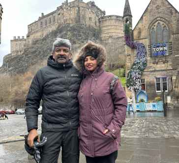 Bundled up in Edinburgh against the dramatic castle backdrop.