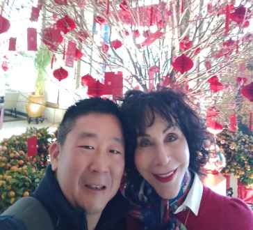 Blossoms and Smiles Amidst a Red Celebration