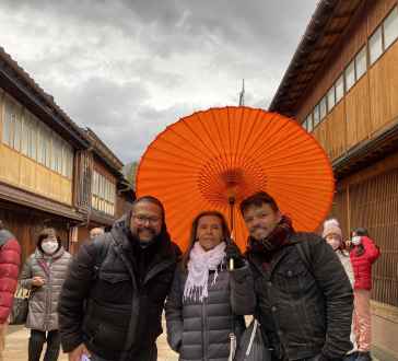 Under the Vibrant Canopy: A Warm Moment Amidst Rainy Skies