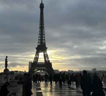 Silhouetted crowd at Trocadéro overlooking the Eiffel Tower.