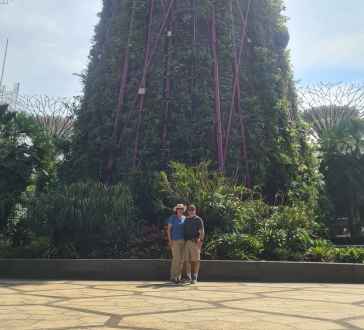 Two people near Supertree Grove in Gardens by the Bay, Singapore.