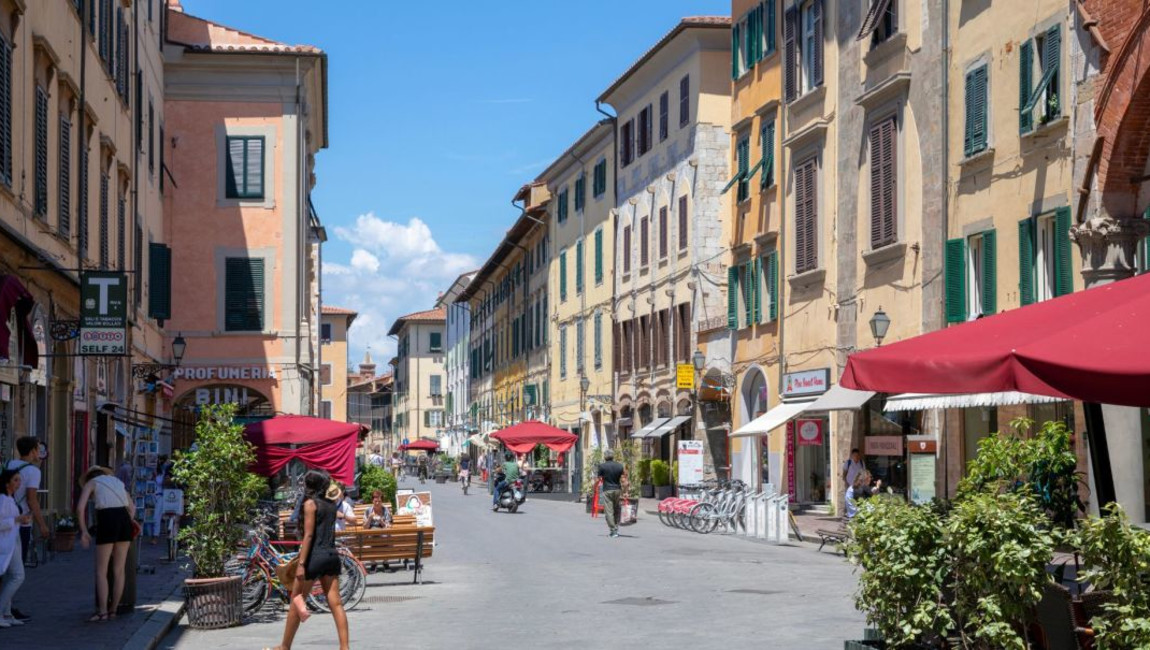 city,urban area,town,road surface,street,public space,pedestrian,neighbourhood,road,summer,urban design,thoroughfare,vacation,mixed-use,bicycle,travel,bicycle tire,bicycle wheel,lane,umbrella,sidewalk,holiday,bicycle frame,walking,bicycles--equipment and supplies