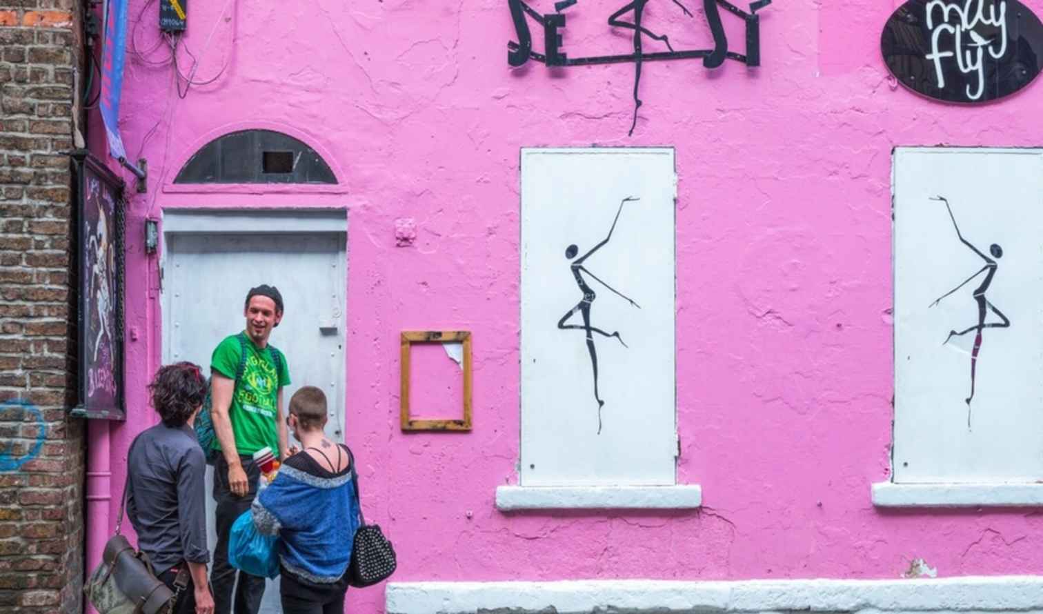 Pink building with dancer murals on Dame Lane, Dublin.