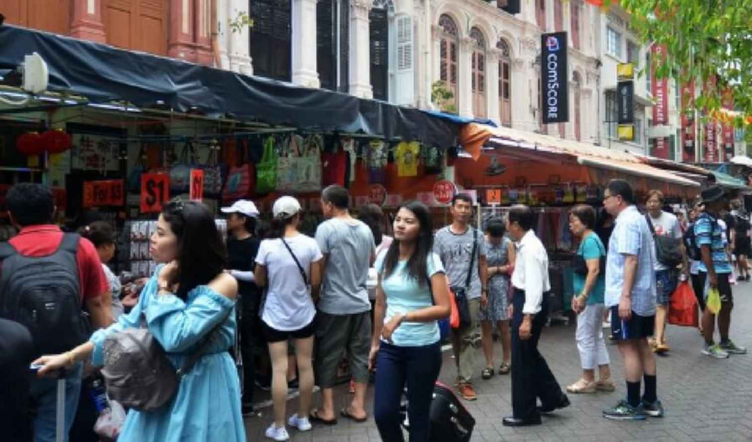 People walking through the street market in Singapore's Chinatown.