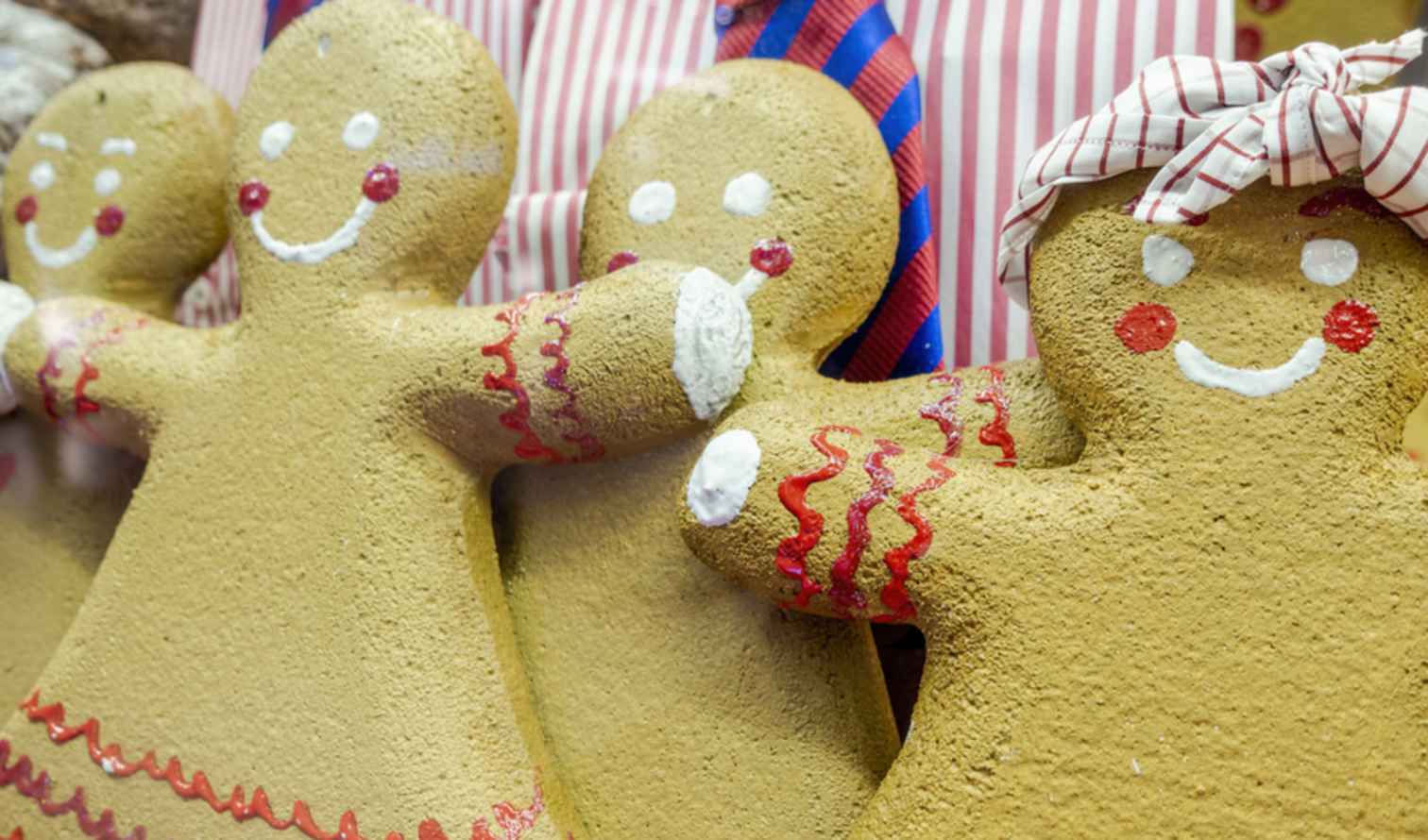 Three gingerbread figures with red details and white frosting smiles in Sydney