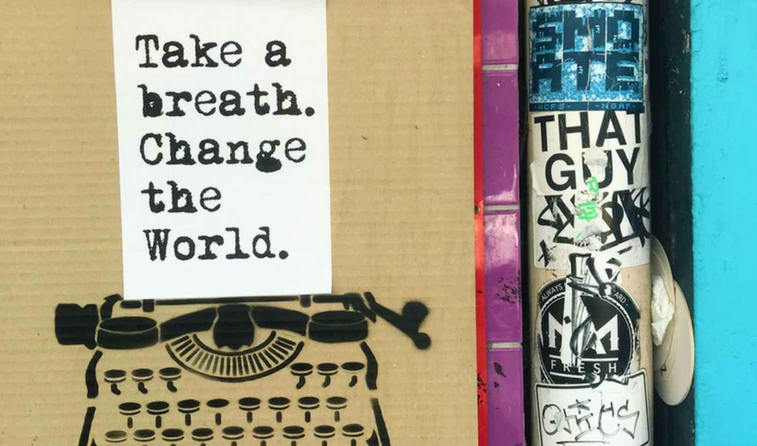 Typewriter stencil beneath sign reading 'Take a breath. Change the World.' in Sydney