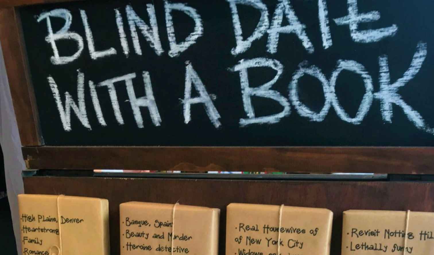 Stack of wrapped books under the 'Blind Date with a Book' sign in Sydney