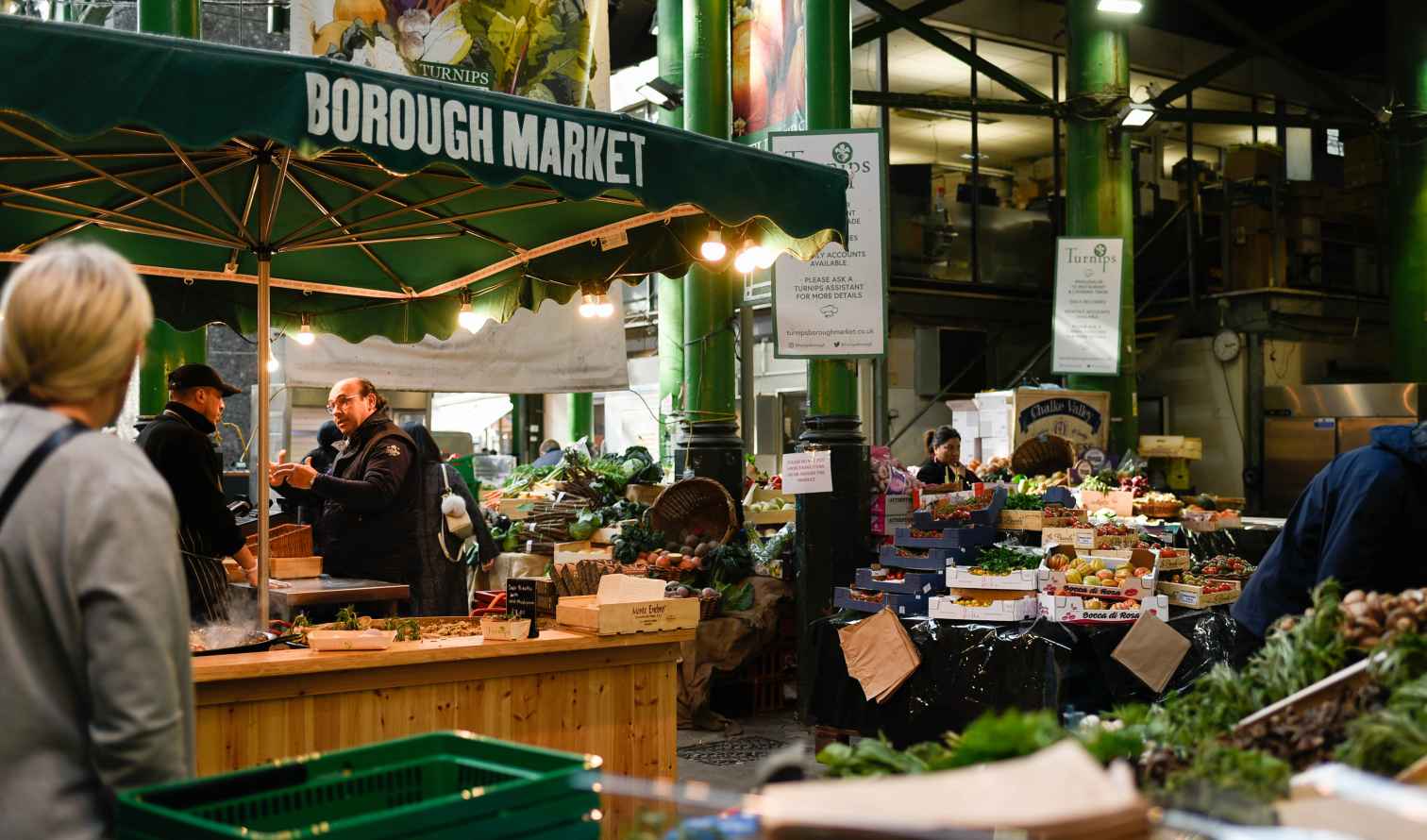 People browsing stalls at Borough Market in London.