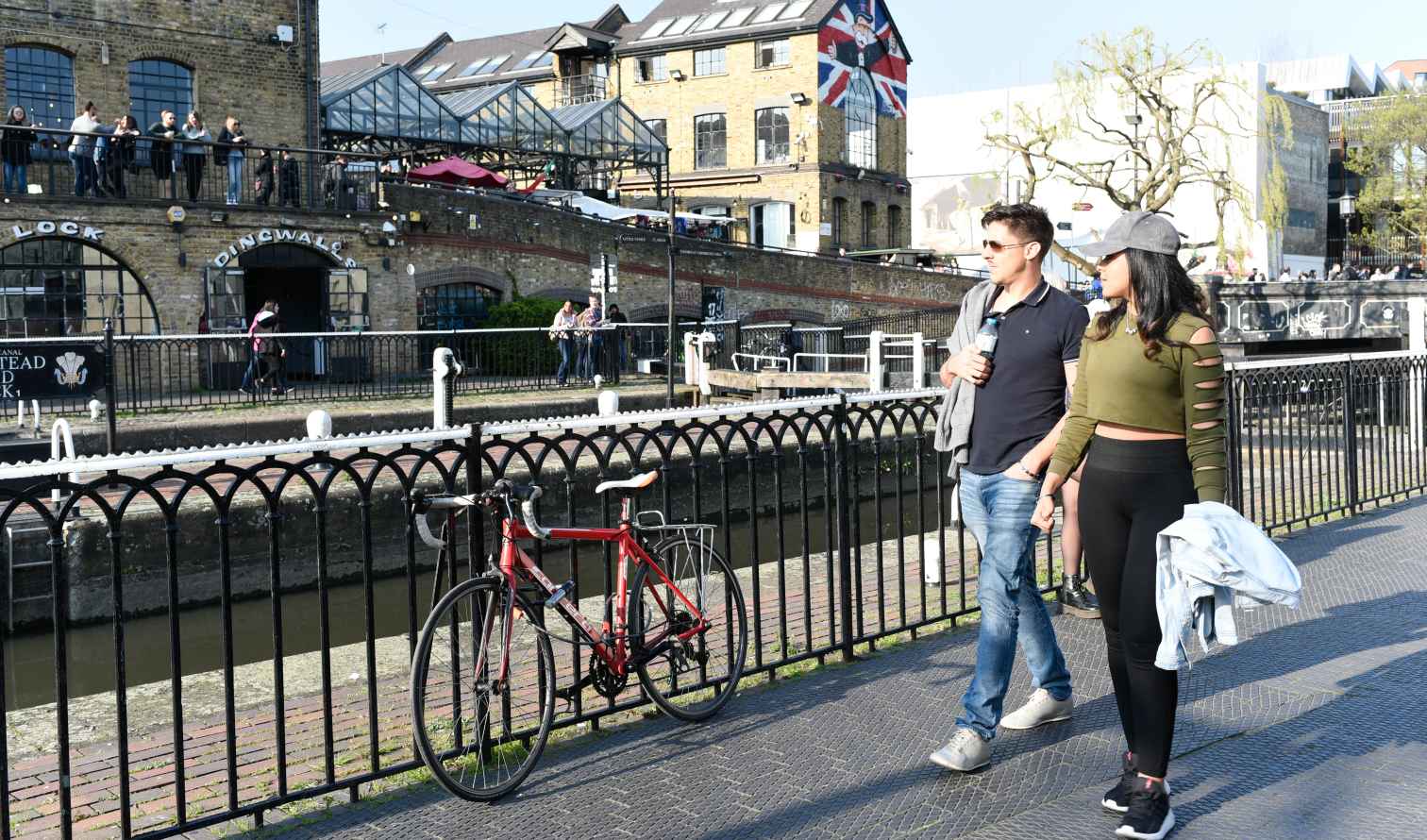 Couple walking along Regent's Canal near Dingwall Building in Camden, London.