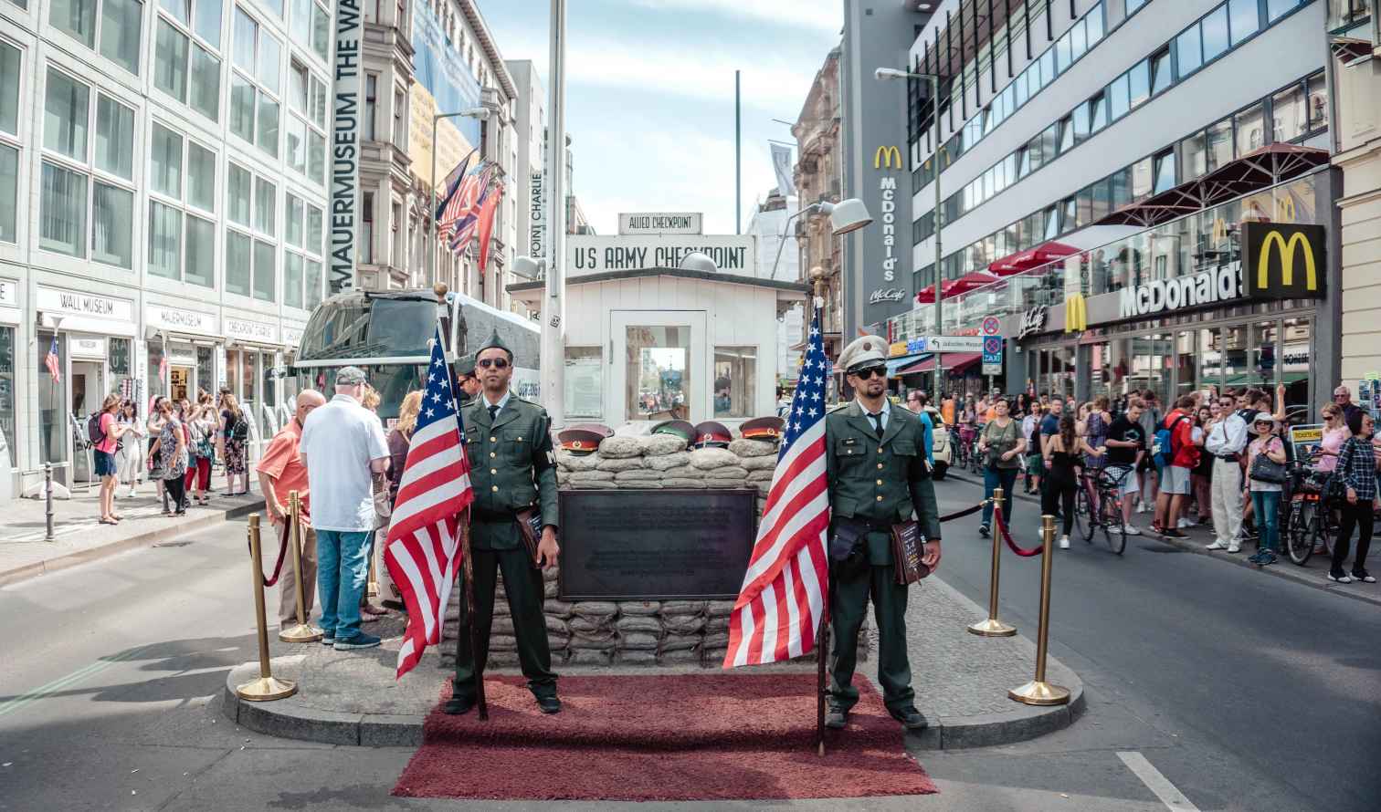 Checkpoint Charlie with guard figures and American flags in Berlin.