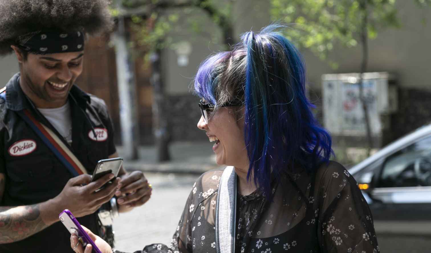Urban street view with people engaged on mobile devices in Mexico