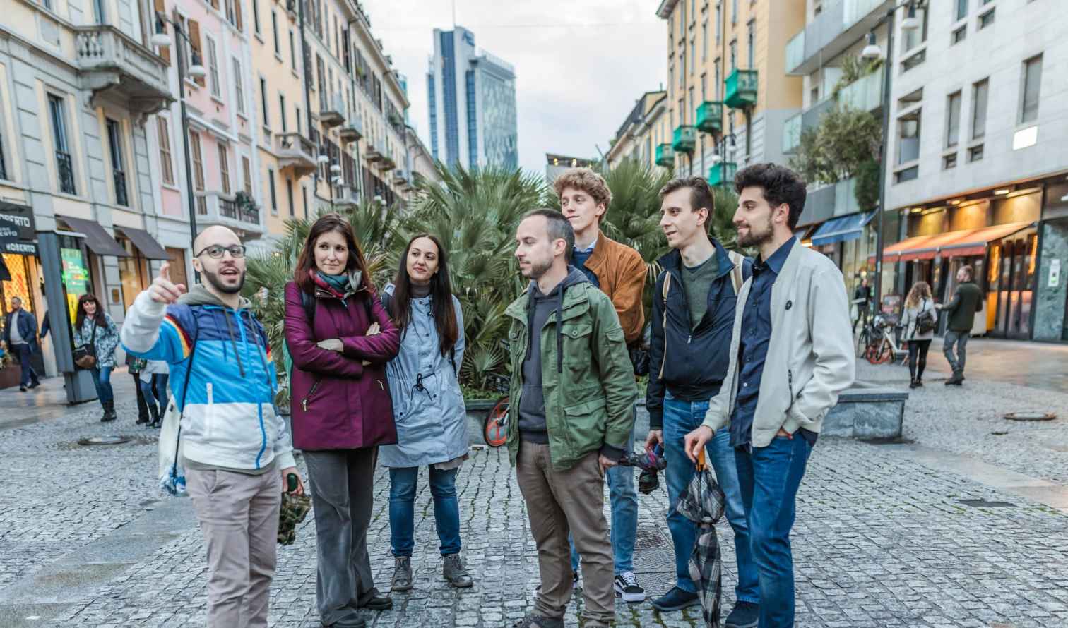 Group of people standing on Via della Moscova, Milan.
