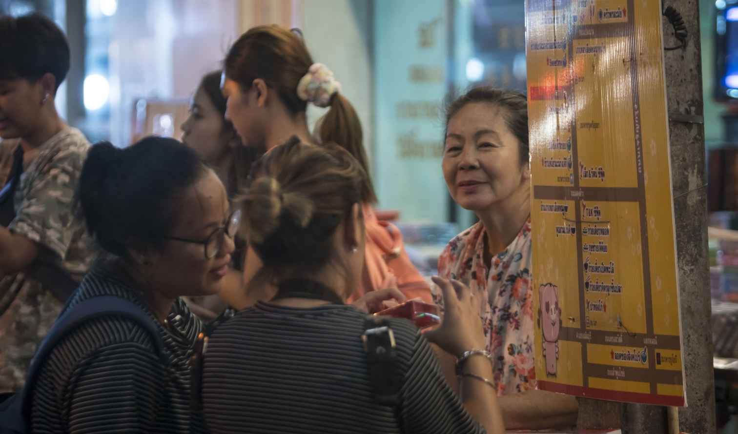 People browsing at a street market in Bangkok, Thailand.