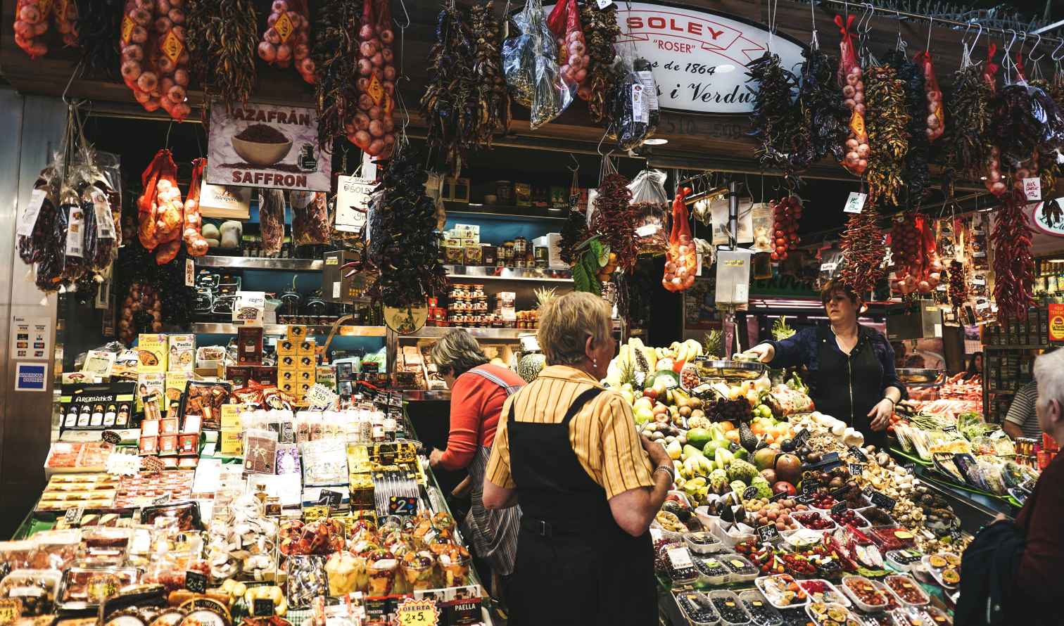 Shoppers at a market stall in La Boqueria, Barcelona.