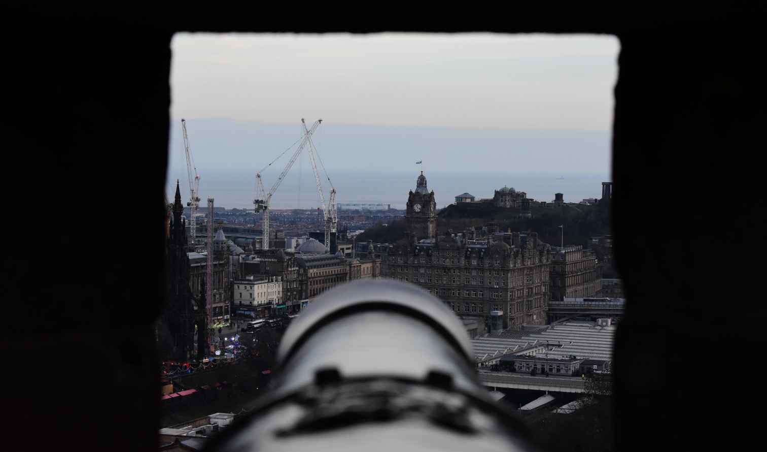 View of Edinburgh from Edinburgh Castle with a cannon in the foreground.